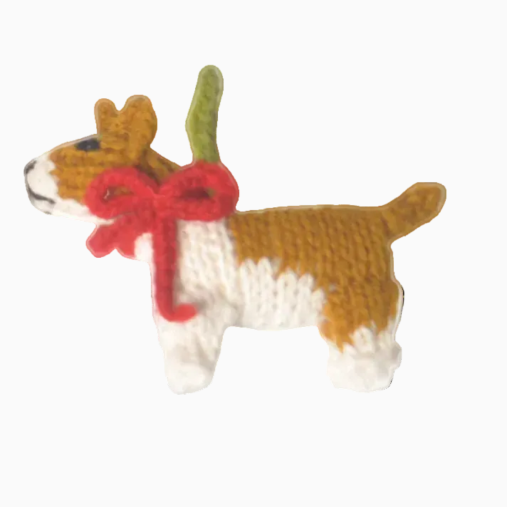 Knitted dog ornament with a red bow on a gray background