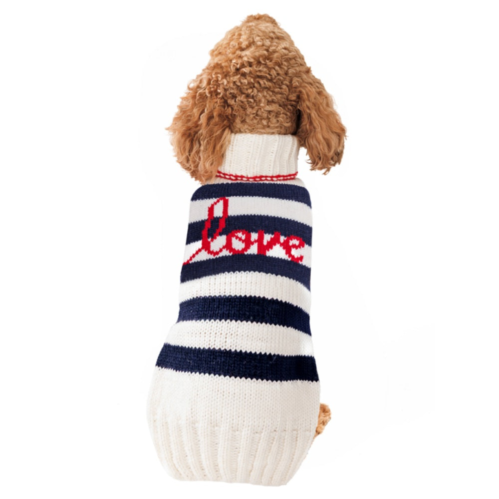 Dog wearing a striped sweater with 'love' on a white background
