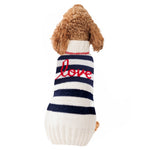Dog wearing a striped sweater with 'love' on a white background