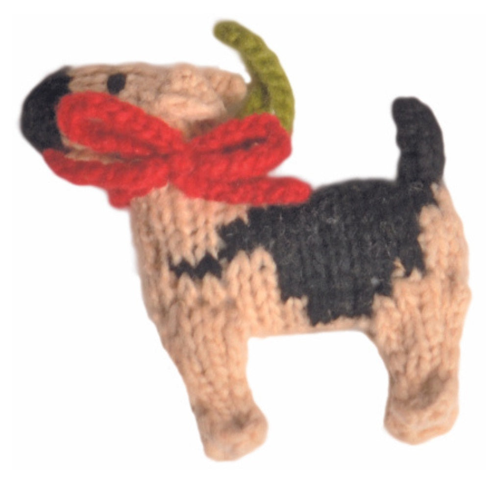 Knitted dog toy with a red bow tie on a white background