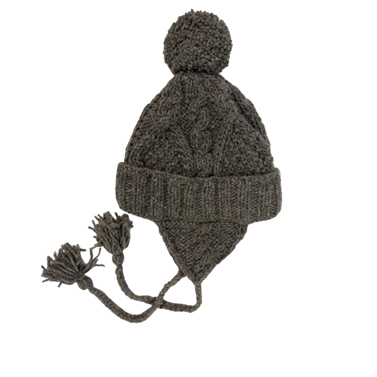 Knitted beanie with earflaps and pom-pom on a white background