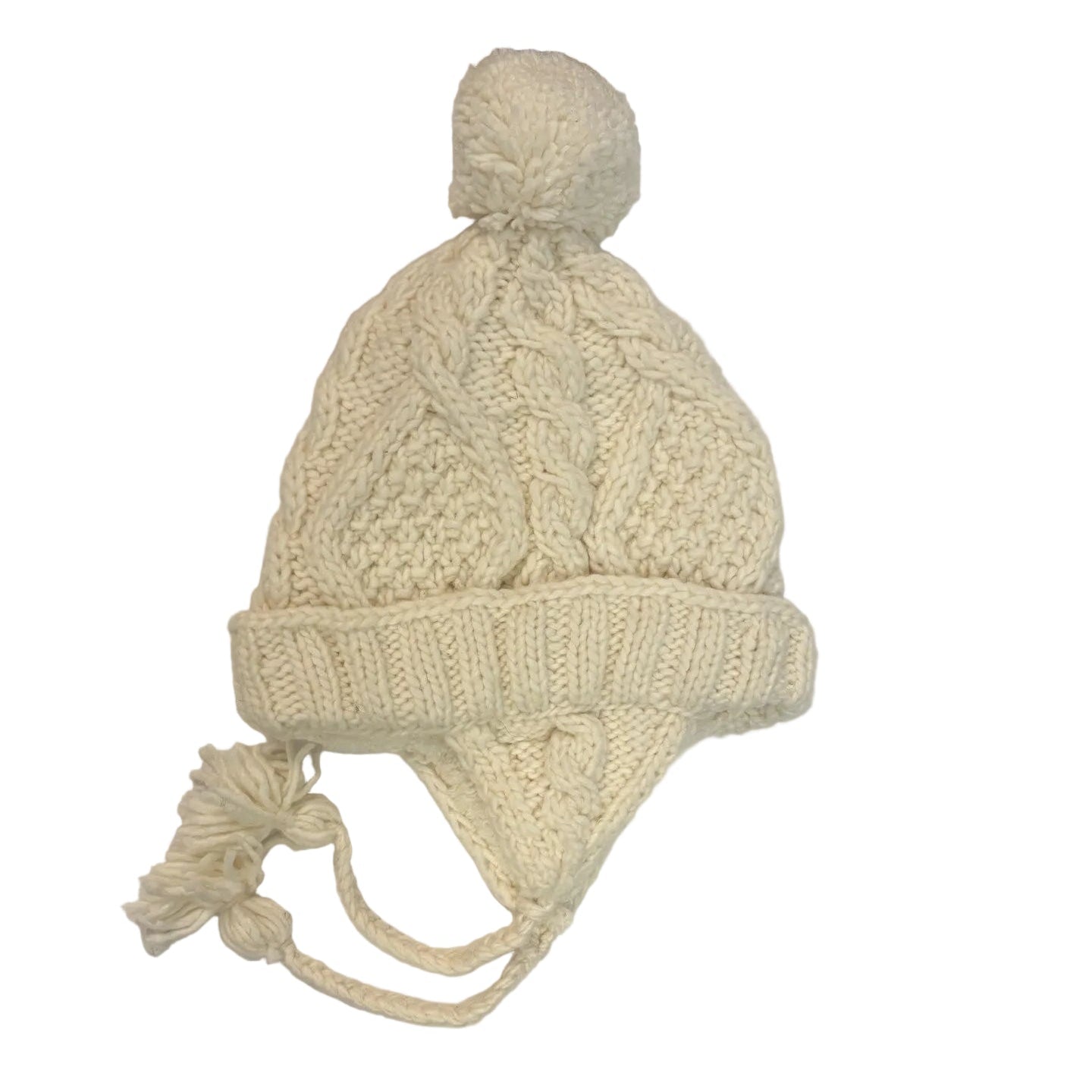 Knitted cream-colored hat with earflaps on a white surface