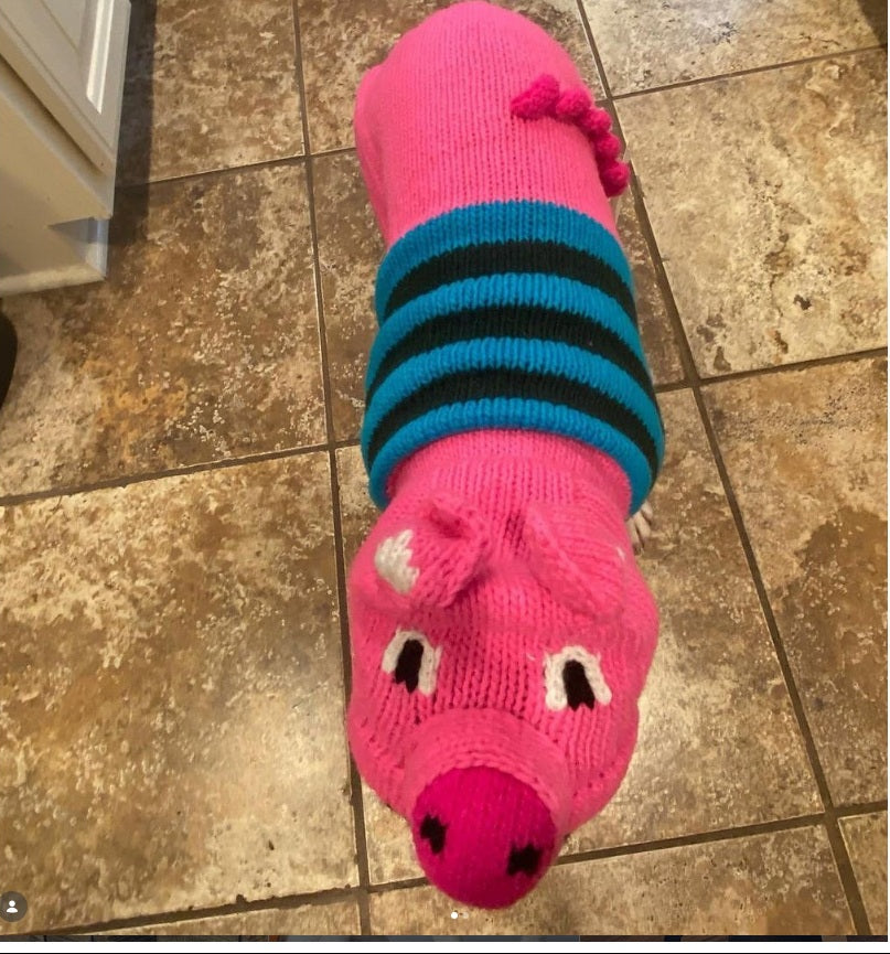 Pink piggy animal face design on dog sweater.